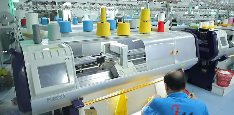 Advanced flat-knitting process at our sweater manufacturer