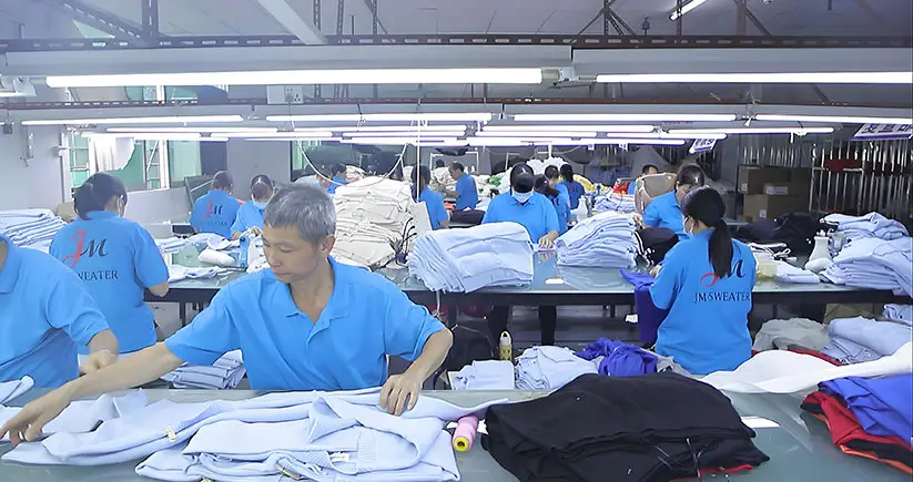 Professional QC inspection at manufacturing sweater factory