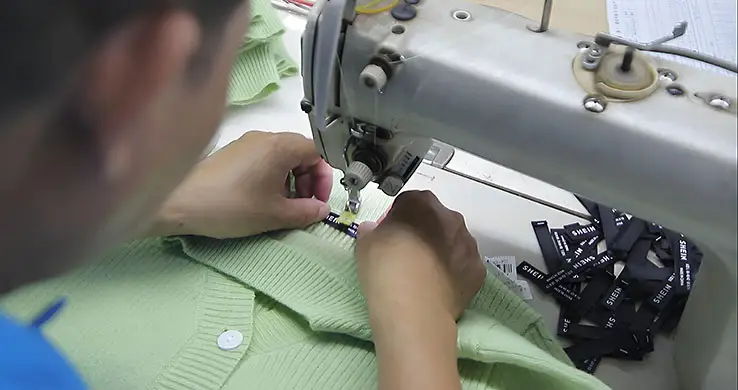 Custom brand label stitching by sweater manufacturer